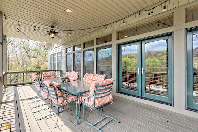 wooden terrace featuring ceiling fan and french doors