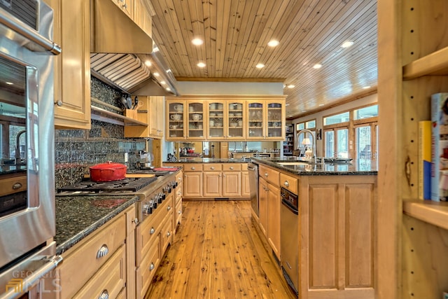 kitchen with sink, premium range hood, dark stone countertops, light hardwood / wood-style floors, and wood ceiling