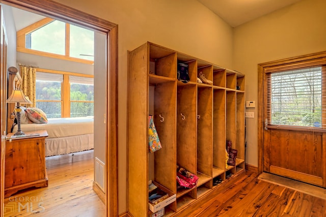 mudroom featuring lofted ceiling and light wood-type flooring