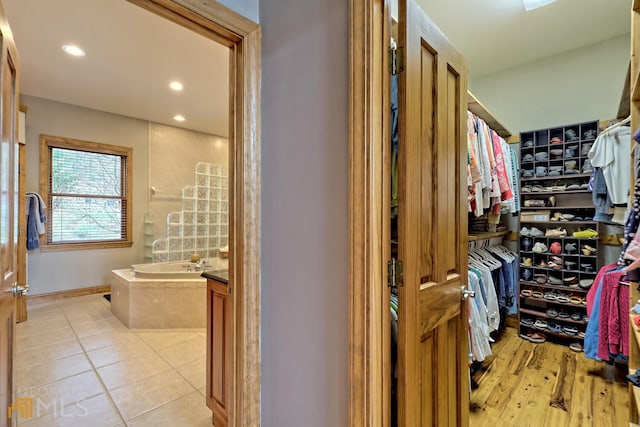 walk in closet featuring light tile patterned flooring