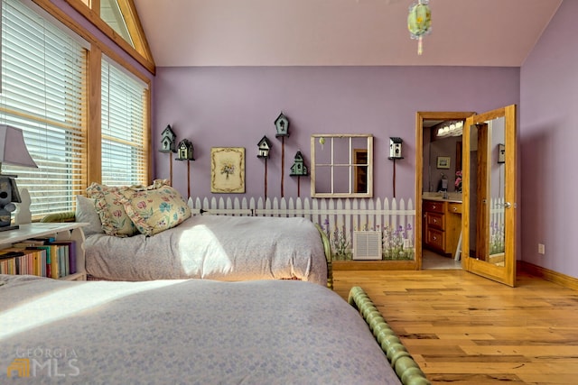 bedroom with lofted ceiling and hardwood / wood-style flooring