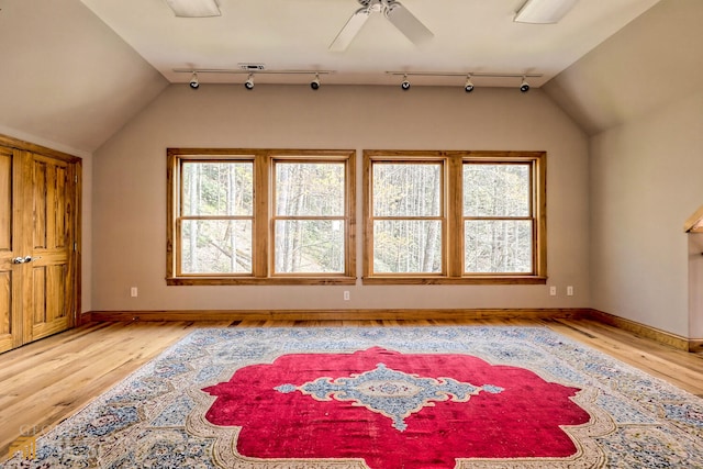 bonus room with ceiling fan, light hardwood / wood-style floors, and vaulted ceiling