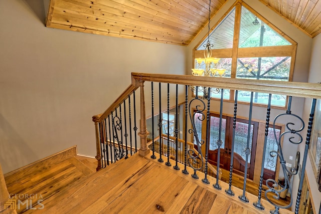 stairway with hardwood / wood-style floors, lofted ceiling, and wood ceiling