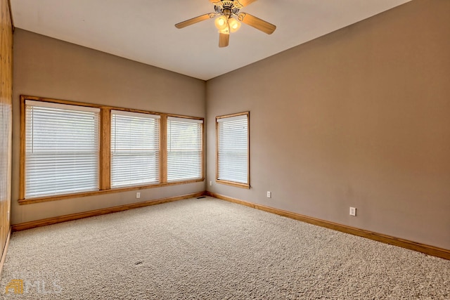 carpeted spare room featuring ceiling fan