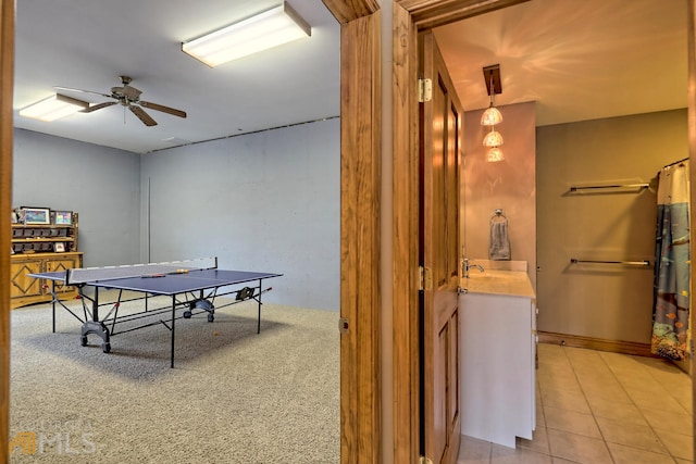 game room featuring ceiling fan, light colored carpet, and sink