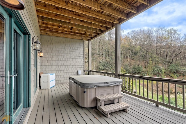 wooden terrace featuring a hot tub