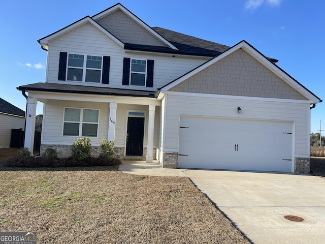 craftsman-style home with a garage, a front yard, and a porch