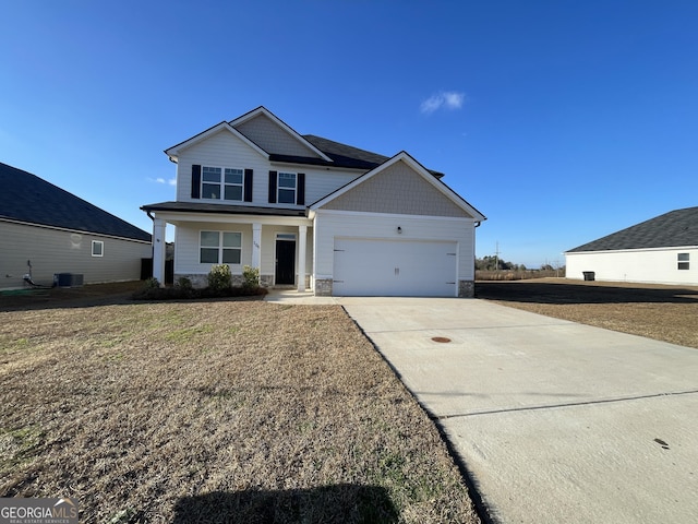 view of front of home with a garage, a porch, central AC unit, and a front lawn