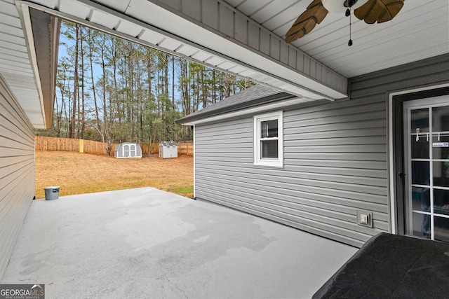 view of patio with a storage unit and ceiling fan