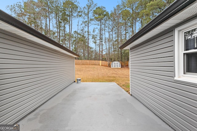 view of patio featuring a storage unit