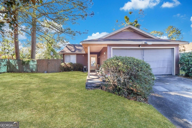 ranch-style house with a garage and a front yard