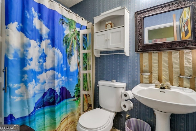 bathroom featuring toilet and walk in shower