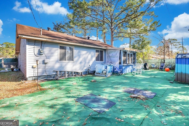 back of house with a sunroom