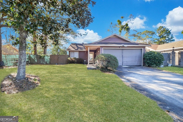 ranch-style home featuring a garage and a front lawn