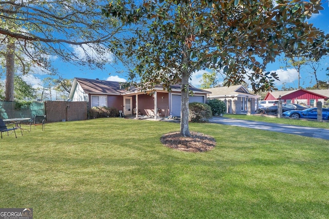 ranch-style home featuring a front yard and a garage