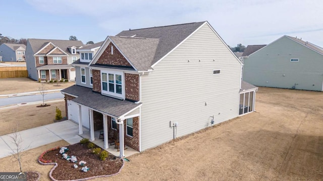 exterior space with a garage and a sunroom