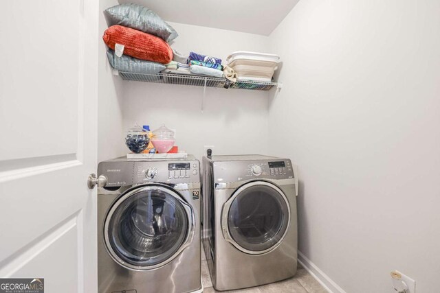 clothes washing area featuring washer and clothes dryer