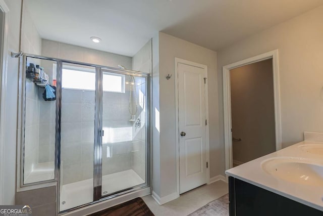 bathroom featuring vanity, tile patterned floors, and a shower with door