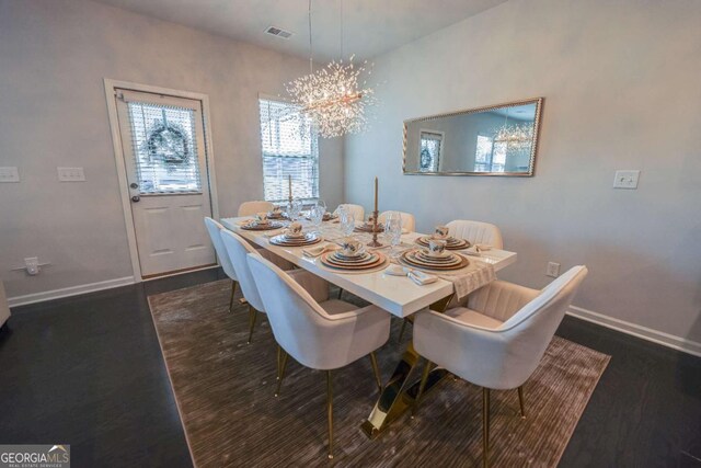 dining room featuring dark wood-type flooring and a chandelier