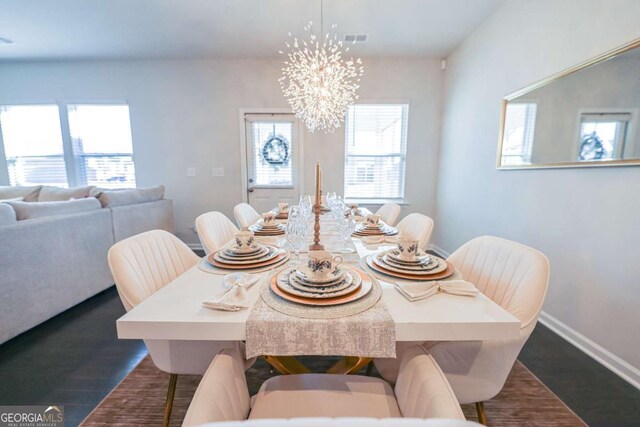 dining area featuring dark hardwood / wood-style floors and a notable chandelier
