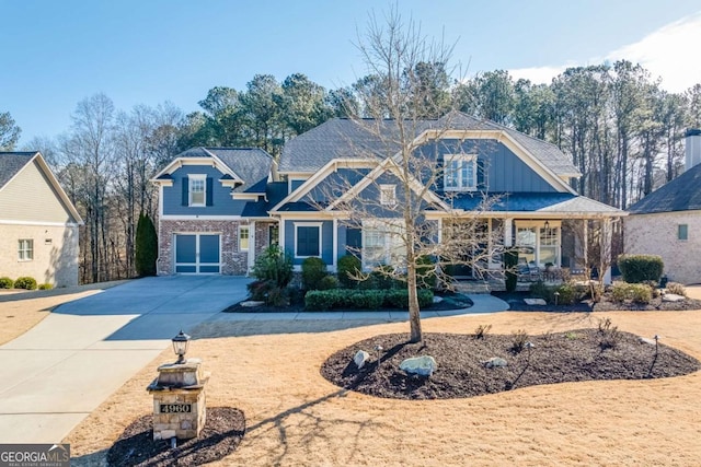 view of front of house featuring driveway, covered porch, and a garage