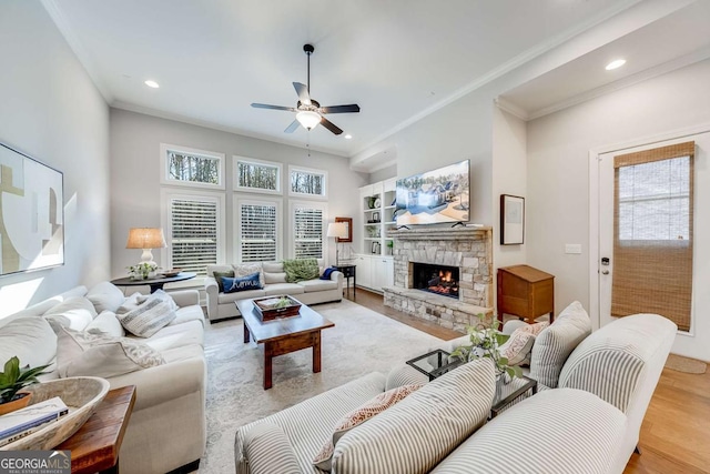 living area featuring light wood-style floors, crown molding, and a wealth of natural light