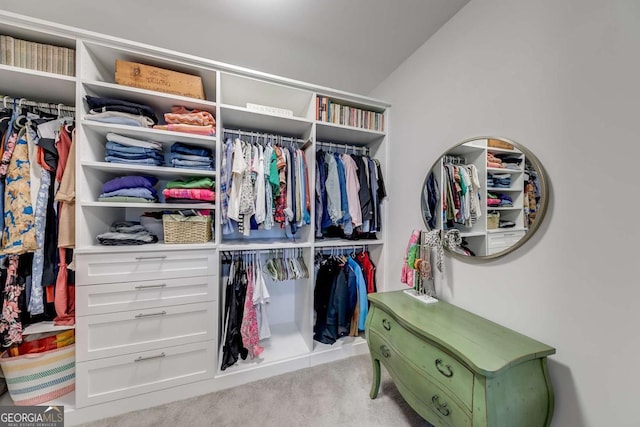 spacious closet featuring lofted ceiling and carpet flooring