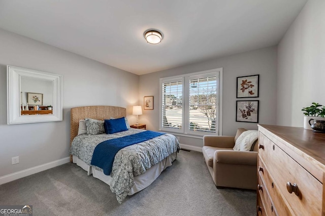 bedroom with baseboards and dark carpet