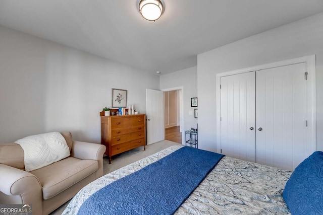 bedroom featuring light carpet and a closet