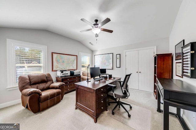 office area featuring ceiling fan, light colored carpet, visible vents, baseboards, and vaulted ceiling