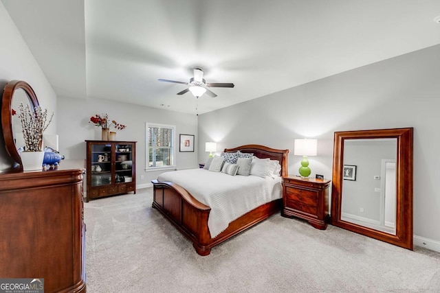 bedroom featuring light carpet, ceiling fan, and baseboards