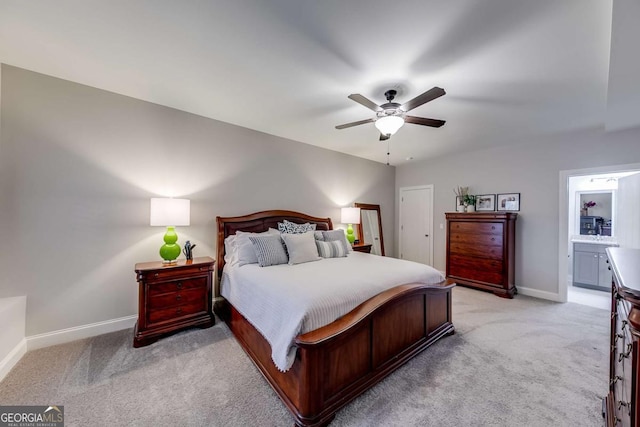 bedroom with baseboards, ceiling fan, connected bathroom, and light colored carpet