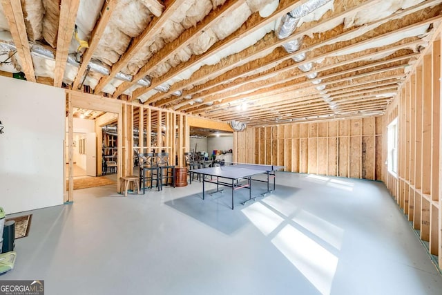 recreation room featuring concrete flooring