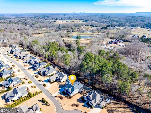 birds eye view of property with a water view and a residential view