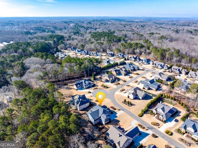 aerial view featuring a forest view and a residential view