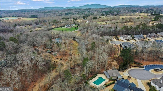 birds eye view of property with a view of trees and a mountain view