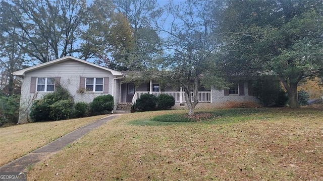 single story home featuring a front lawn and a porch