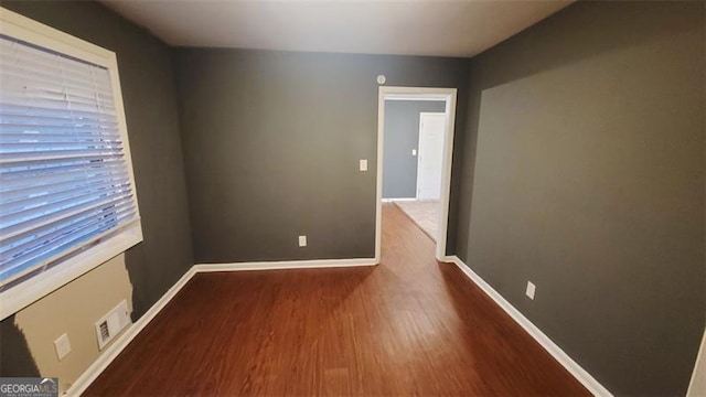 spare room featuring wood-type flooring