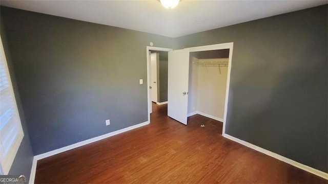 unfurnished bedroom featuring hardwood / wood-style floors and a closet