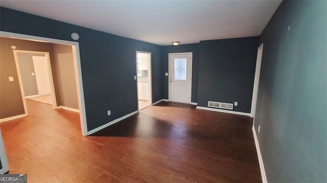 empty room with hardwood / wood-style floors