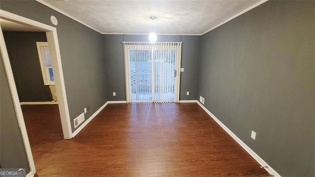 unfurnished dining area featuring crown molding and dark hardwood / wood-style flooring