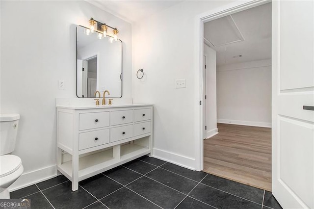 bathroom featuring tile patterned floors, vanity, and toilet