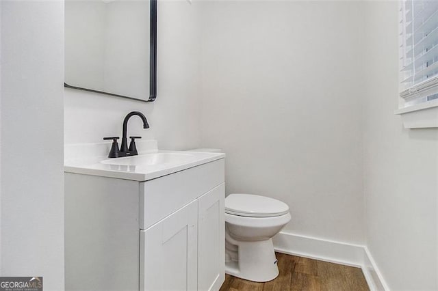 bathroom with vanity, wood-type flooring, and toilet