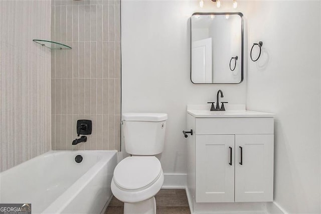 full bathroom featuring vanity, tiled shower / bath combo, and toilet