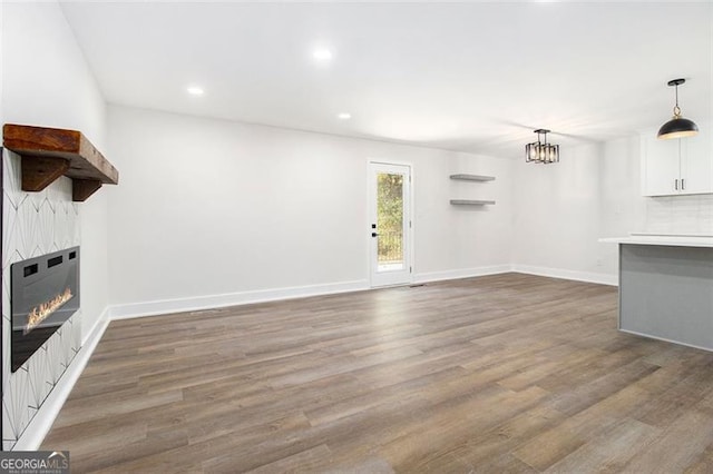 unfurnished living room featuring a fireplace and dark hardwood / wood-style flooring