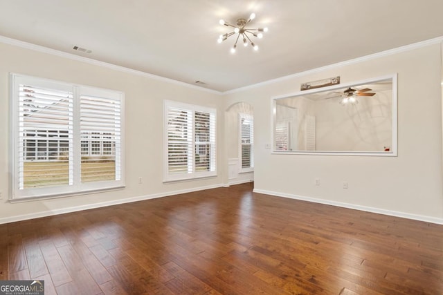 spare room with dark hardwood / wood-style floors, crown molding, and ceiling fan with notable chandelier