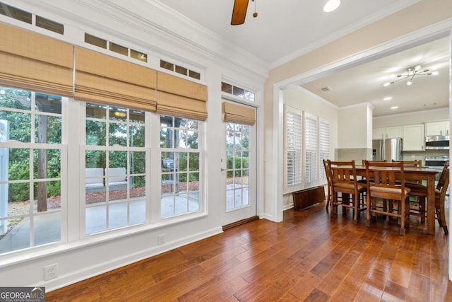 dining space featuring ceiling fan, ornamental molding, and dark wood-type flooring