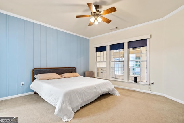 bedroom featuring carpet, ceiling fan, and crown molding