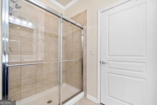 bathroom with a shower with door and ornamental molding