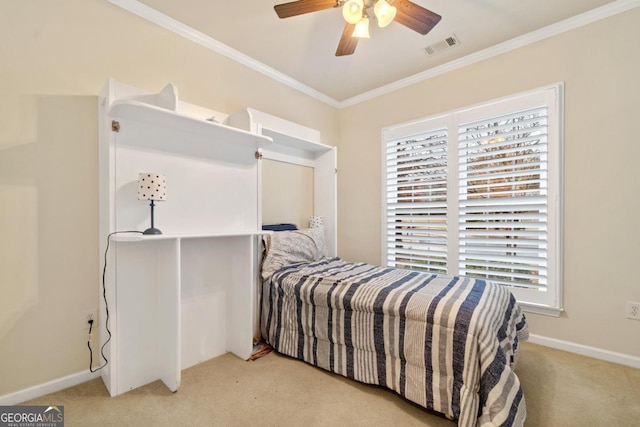 carpeted bedroom with ceiling fan and crown molding